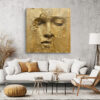Serene human face emerging from cracked gold surface, warm gold and amber tones, dramatic mixed-media portrait canvas art