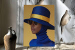 Woman in wide-brim hat with gold band and royal blue head wrap, high-contrast fashion portrait canvas for living room