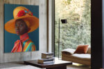 Woman in wide-brim hat with red fabric rose and multicolor striped garment, bold portrait photography canvas wall art