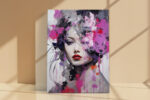 Woman's face with floral paint splatters in magenta and purple, dramatic mixed-media portrait canvas for living room
