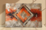 Concentric diamond motif on cracked plaster in burnt orange and charcoal, bold abstract mixed-media wall art canvas