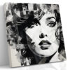 Woman's face with geometric shards and ink splatter in black and white, bold mixed-media portrait canvas wall art