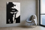Extreme close-up of dark lips and fingers in monochrome chiaroscuro, bold portrait canvas for contemporary living room