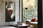 Extreme close-up portrait, vivid crimson lips on monochrome skin, bold high-contrast wall art for contemporary spaces