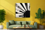 Bold monochrome rising sun with radiating rays and ink splatter, contemporary mixed-media abstract canvas for living room
