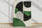 Bold abstract circles and cracked-cell pattern in near-black, warm off-white, and medium green u2014 contemporary canvas wall art