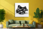 Glossy black abstract sculpture with looping voids on white background, bold minimalist wall art canvas for living room