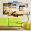 A rhinoceros stands on a sandy beach at sunset, split across five panels