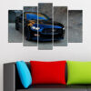 A sleek black sports car dominates this five-panel canvas, positioned on dark asphalt