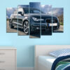 This five-piece canvas shows a vehicle on a rain-slicked highway beneath heavy storm clouds