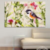 A small bird sits among clusters of soft pink blossoms and fresh green leaves