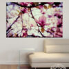 A flowering tree in full spring bloom, branches heavy with pink and white blossoms