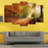 A forest path winds through autumn trees in warm golds, oranges, and browns