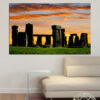 Ancient standing stones rise against a golden sunset sky