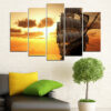 This five-piece canvas set captures a sunset spreading warm light across still water