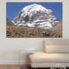 A snow-covered mountain peak rises against a pale sky