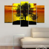 Three trees stand silhouetted against a sunset sky over a calm bay