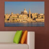 A waterfront cityscape with golden domes and spires rising against a warm amber sky