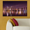 This canvas shows city lights reflected in still water at night