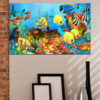 An orange and white clownfish swims through a coral reef against deep blue water