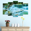 This five-piece canvas set shows a waterfall flowing through dense forest