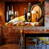 A glass of red wine sits alongside aged cheese wedges and clusters of fresh grapes