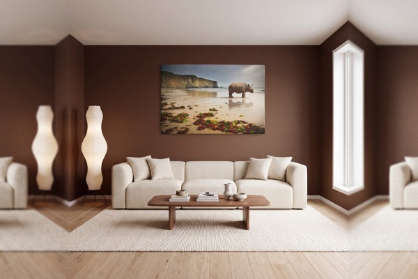 Neushoorn op zandstrand canvas print - aan de muur in een interieur