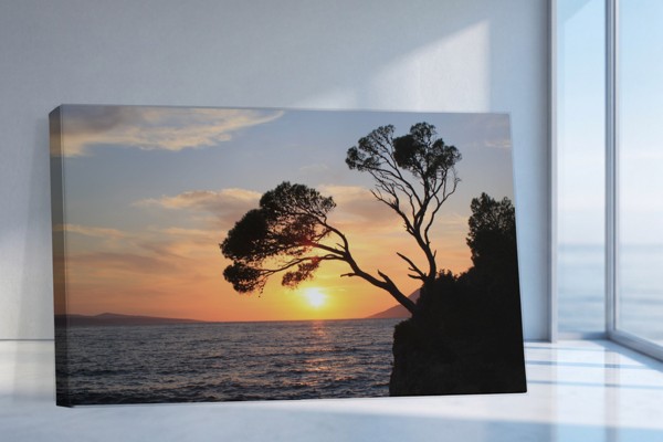 Lonely Sunset Over Calm Water Canvas Print - on the wall in a room interior